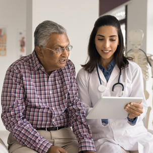 Person reading tablet with doctor